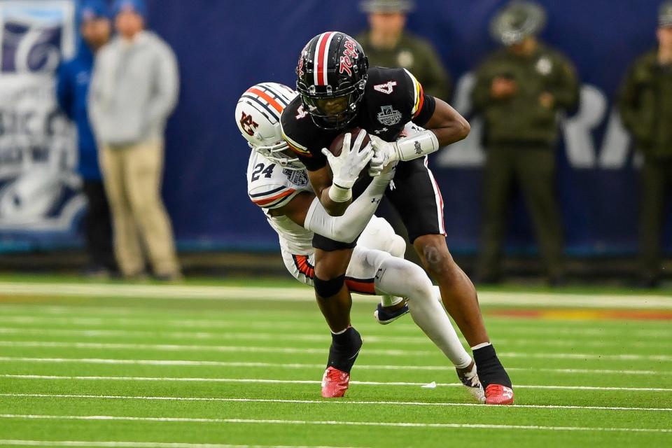 Dec 30, 2023; Nashville, TN, USA; Maryland Terrapins wide receiver Shaleak Knotts (4) gets tackled by Auburn Tigers cornerback Colton Hood (24) during the second half at Nissan Stadium. Mandatory Credit: Steve Roberts-USA TODAY Sports