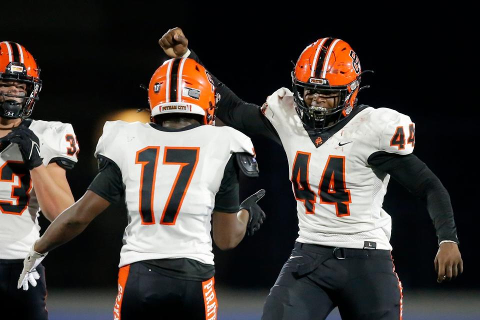 Putnam City's Taje McCoy, right, celebrates after a sack during a high school football game between the Deer Creek Antlers and the Putnam City Pirates at Deer Creek, Friday, Sept. 30, 2022.