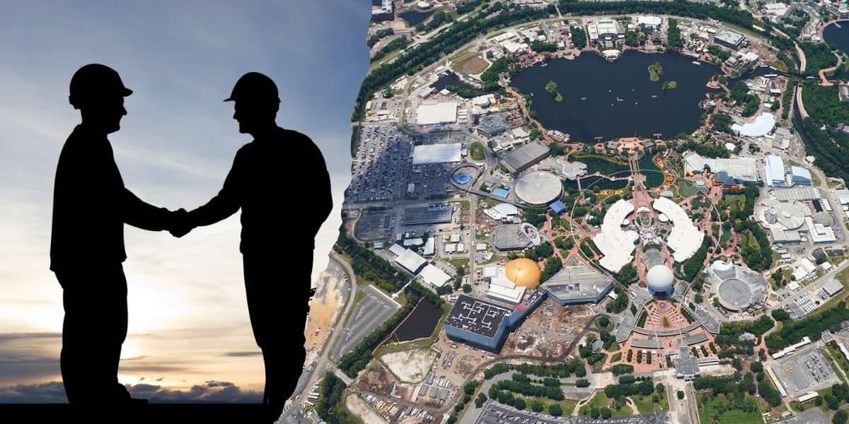 Two construction workers shake hands inside of EPCOT at Walt Disney World Resort in preparation for Test Track.