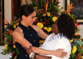 Meghan Markle Arrives in Colombia Wearing a Navy Vest and Trousers