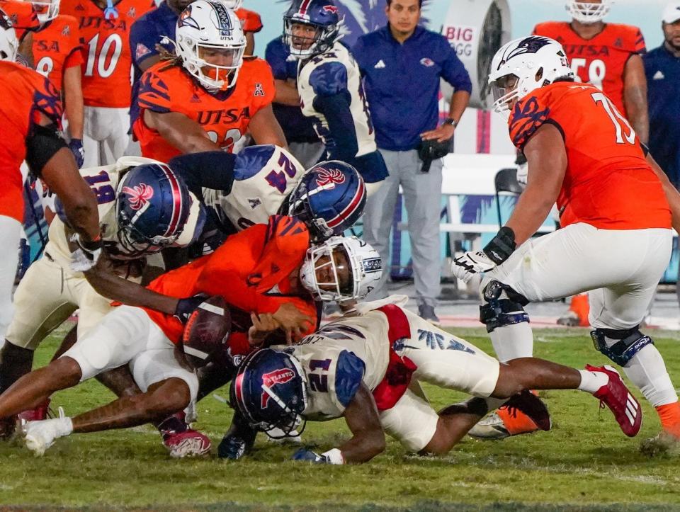 Florida Atlantic linebacker Jaylen Wester (21) forces a fumble during the fourth quarter of game against UTSA at FAU Stadium on Saturday, October 21, 2023, in Boca Raton, FL.