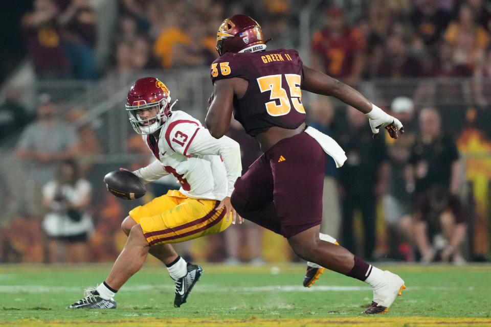 Sep 23, 2023; Tempe, Arizona, USA; USC Trojans quarterback Caleb Williams (13) runs against Arizona State Sun Devils defensive lineman B.J. Green II (35) during the second half at Mountain America Stadium, Home of the ASU Sun Devils. Mandatory Credit: Joe Camporeale-USA TODAY Sports