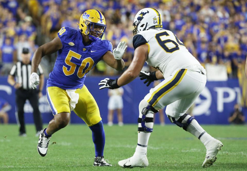 Sep 1, 2022; Pittsburgh, Pennsylvania, USA; Pittsburgh Panthers defensive lineman Dayon Hayes (50) pass rushes against West Virginia Mountaineers offensive lineman Wyatt Milum (64) during the third quarter at Acrisure Stadium. Mandatory Credit: Charles LeClaire-USA TODAY Sports