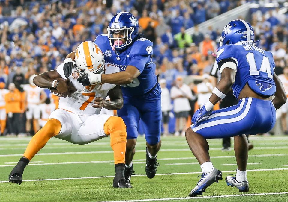 Kentucky Wildcats linebacker Keaten Wade (20) sacks Tennessee quarterback Joe Milton III in the fourth quarter but it wasn't enough to stop the Volunteers as the Cats fell 33-27 Saturday night in Lexington. Kentucky is now 5-3 for the season. Oct. 28, 2023.