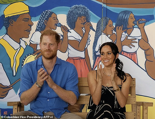 Harry and Meghan clapping during a performance at La Boquilla drum school in Cartagena