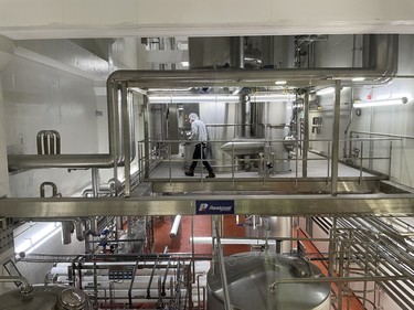 A worker walks on some of the equipment inside the Canada Royal Milk facility in Kingston, Ont. on Tuesday, August. 13, 2024. Elliot Ferguson/The Whig-Standard/Postmedia Network