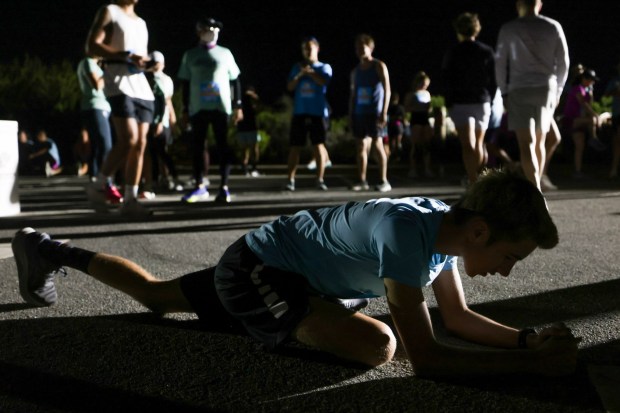 Roy Lessard stretches before a 6:15 am start time at Cabrillo National Monument during the 47th annual America's Finest City Half Marathon and 5K in San Diego on Sunday, Aug. 18, 2024. Over 1,300 people participated in the 5K and more than 4,300 in the half marathon. (Hayne Palmour IV / For The San Diego Union-Tribune)