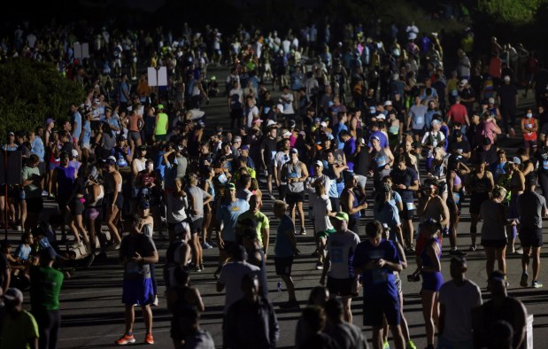 Thousands of half marathon runners are gathered in a parking lot as they wait for a 6:15 am start time at Cabrillo National Monument during the 47th annual America's Finest City Half Marathon and 5K in San Diego on Sunday, Aug. 18, 2024. Over 1,300 people participated in the 5K and more than 4,300 in the half marathon. (Hayne Palmour IV / For The San Diego Union-Tribune)