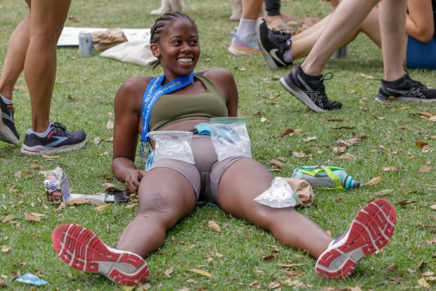 After finishing, half marathon runner Olivia Jones relaxes with bags filled with ice placed on her legs during the 47th annual America's Finest City Half Marathon and 5K in San Diego on Sunday, Aug. 18, 2024. Over 1,300 people participated in the 5K and more than 4,300 in the half marathon. (Hayne Palmour IV / For The San Diego Union-Tribune)