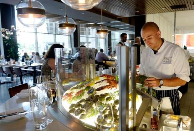 Jordy Lee works the raw bar at the Guard and Grace restaurant in downtown Denver. (Denver Post Photo by Cyrus McCrimmon)