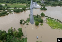 La Plata river floods a road after Tropical Storm Ernesto passed through Toa Baja, Puerto Rico, Aug. 14, 2024.