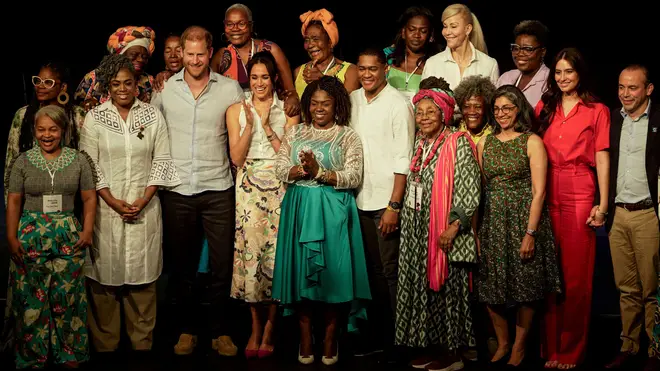 Prince Harry and Meghan smile for a group photo during forum on Afro women and power in Cali, Colombia