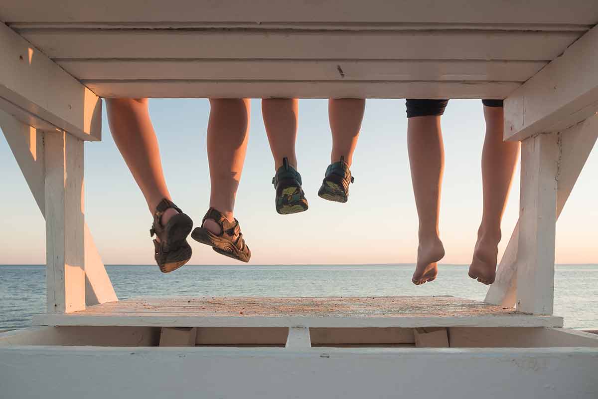 beaches in massachusetts Family with their feet hanging at sunset in Cape Cod