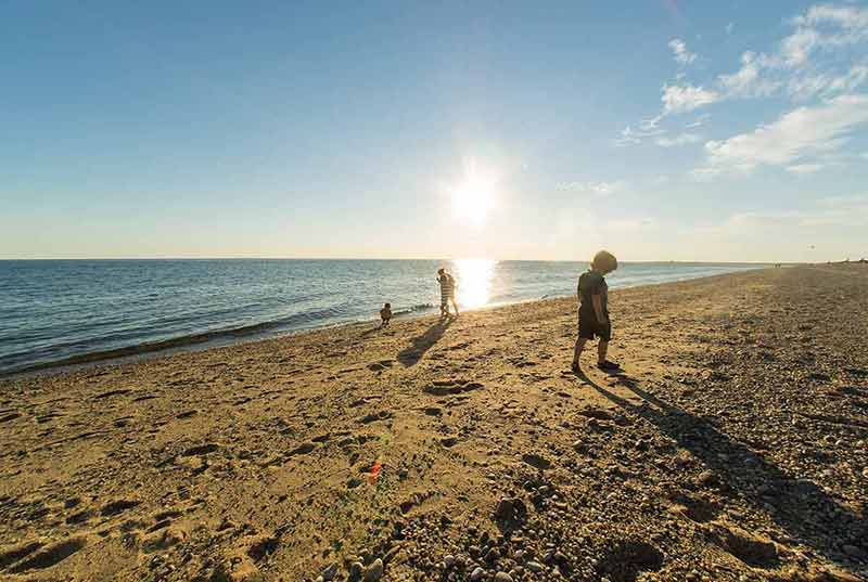free beaches in massachusetts kids playing on the sand at sunset