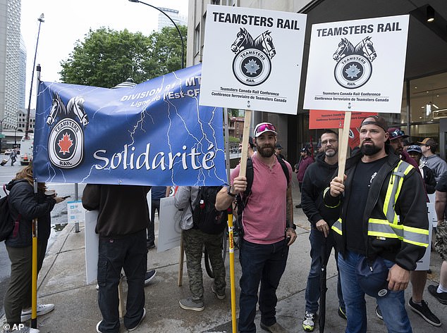 Rail workers picket in front of CN headquarters on the first day of a nationwide rail shutdown