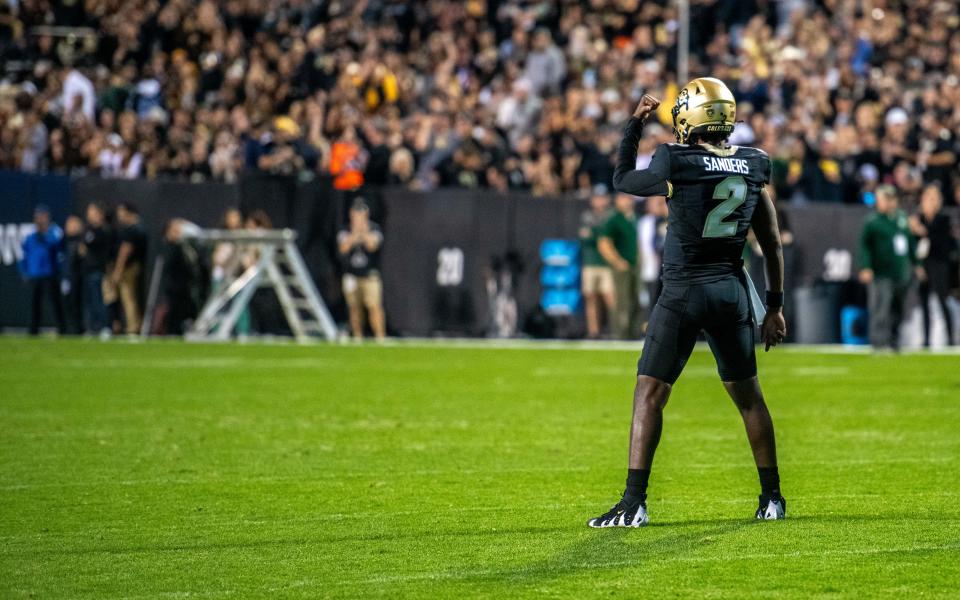 CU football's junior quarterback Shedeur Sanders flexes for the crowd before the Rocky Mountain Showdown on Sept. 16, 2023 at Folsom Field in Boulder, Colo.