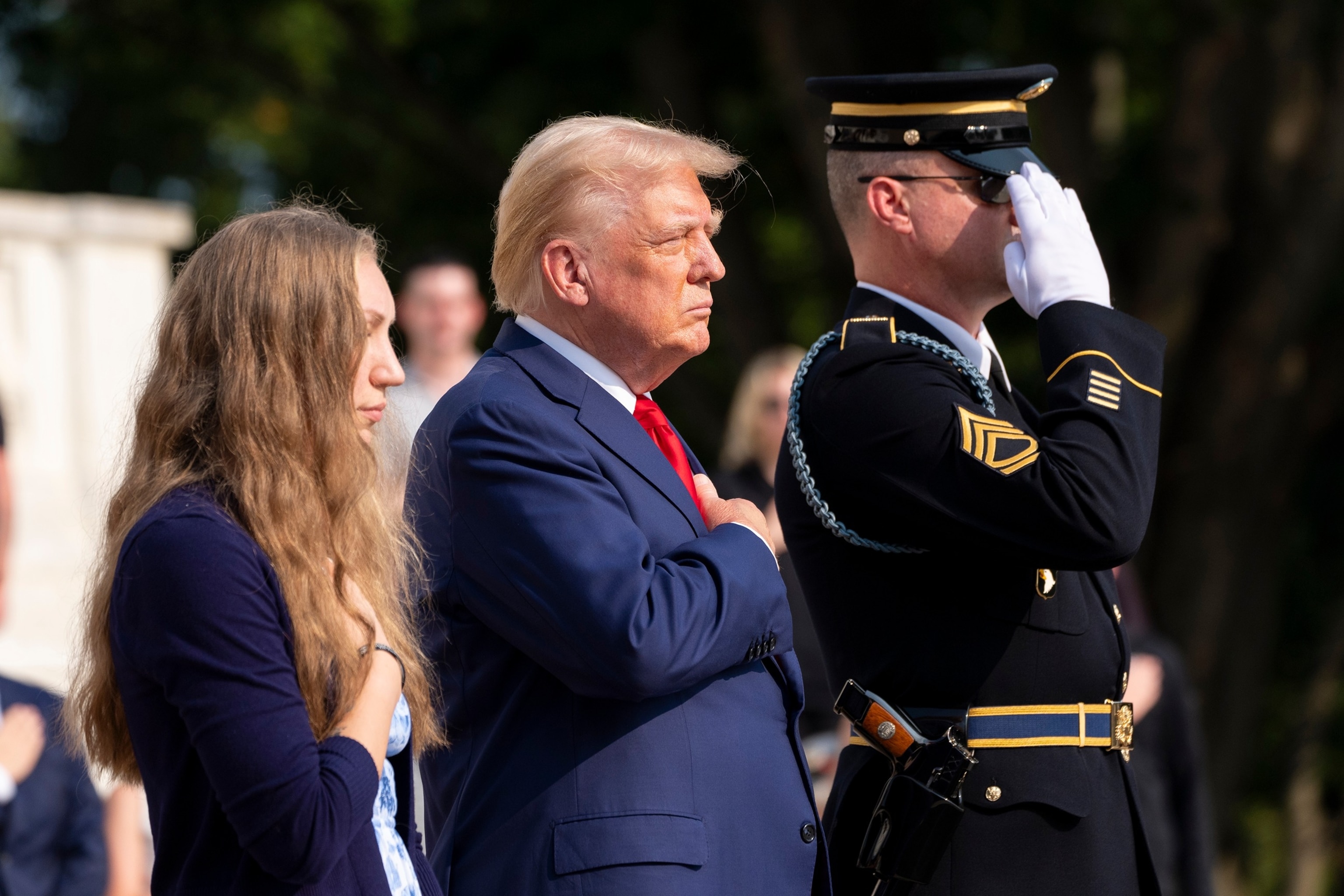 PHOTO: Misty Fuoco, left, sister of Nicole Gee, and Donald Trump place their hands over their heart after placing a wreath in honor of Sgt. Nicole Gee, at the Tomb of the Unknown Solider at Arlington National Cemetery, Aug. 26, 2024, in Arlington, Va.