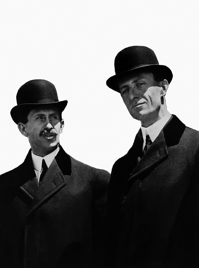 Orville and Wilbur Wright wearing suits and bowler hats