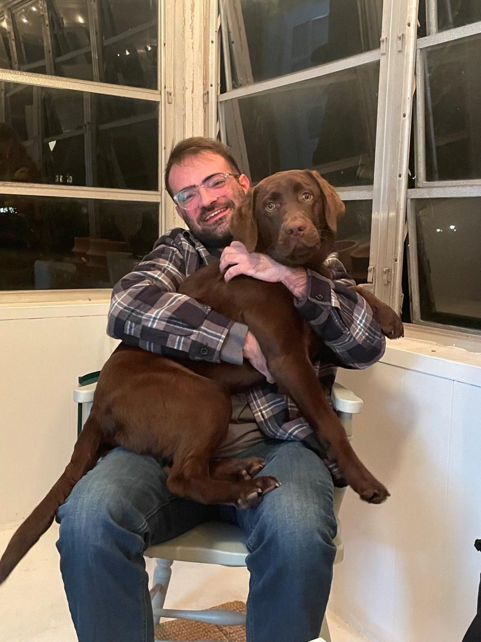 USA TODAY trending reporter Gabe Hauari with his dog, Lola, a 2-year-old chocolate lab.