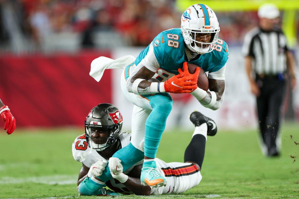 Aug 23, 2024; Tampa, Florida, USA; Miami Dolphins tight end Jody Fortson Jr. (88) is brought down by Tampa Bay Buccaneers linebacker Chris Braswell (43) in the third quarter during preseason at Raymond James Stadium. Mandatory Credit: Nathan Ray Seebeck-USA TODAY Sports