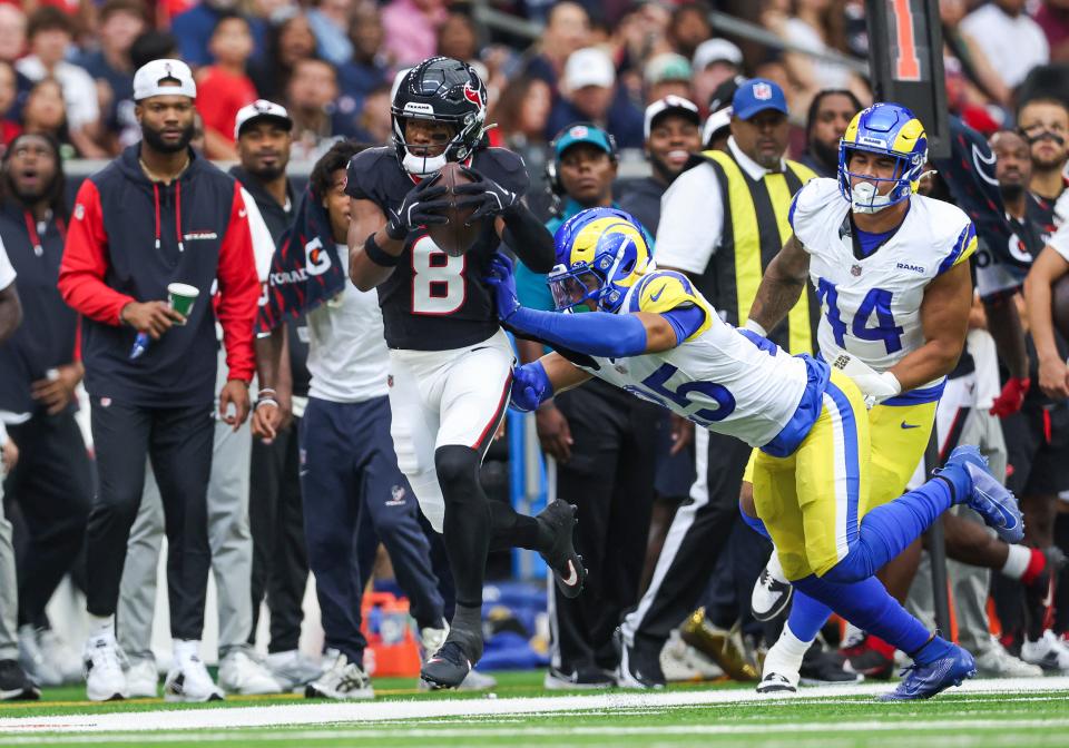 Aug 24, 2024; Houston, Texas, USA; Houston Texans wide receiver John Metchie III (8) runs with the ball as Los Angeles Rams safety Jason Taylor II (25) attempts to make a tackle during the first quarter at NRG Stadium. Mandatory Credit: Troy Taormina-USA TODAY Sports