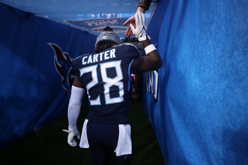 LONDON, ENGLAND - OCTOBER 15: Shyheim Carter #28 of the Tennessee Titans shakes hands with a fan as they walk down the tunnel after the team's defeat during the 2023 NFL London Games match between Baltimore Ravens and Tennessee Titans at Tottenham Hotspur Stadium on October 15, 2023 in London, England. (Photo by Alex Pantling/Getty Images)