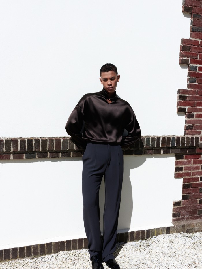 Diop wears Saint Laurent by Anthony Vaccarello silk satin high-neck blouse, £1,460, silk crepe trousers, £1,640, and patent-leather Derby shoes, £820