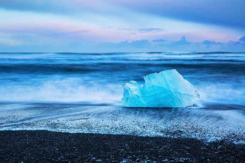 beach with black sand iceberg on sand
