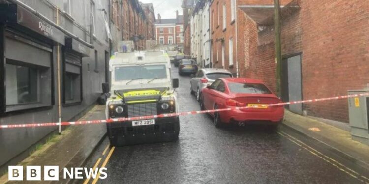 Police vehicles pictured at the scene following the fire in Harvey Street