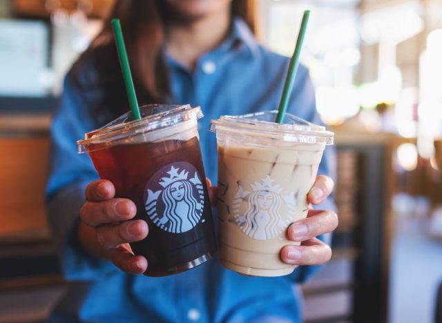 Starbucks customer holding two iced coffee cups