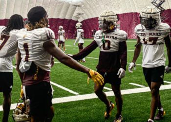 Arizona State defensive backs Cole Martin (#0) and Rodney Bimage Jr. (#17) greet teammates after br...