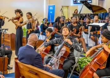Gemma Hazelwood Members of the Kanneh-Mason family (Sheku plays the cello front centre) during a performance with the Antigua and Barbuda Youth Symphony Orchestra