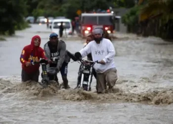 EPA People cross a flooded road as a result of the intense rains, in San Jose de Ocoa, Dominican Republic 18 November 2023.