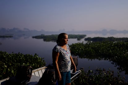 Fatima Brandao looks at smoke rising from a forest fire in the Pantanal, in the state of Mato Grosso do Sul, Brazil, on June 12, 2024. 