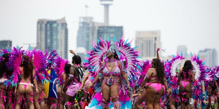 Costumed dancers and mas bands add sizzle to a sweltering day at the Toronto Caribbean Carnival Grand Parade