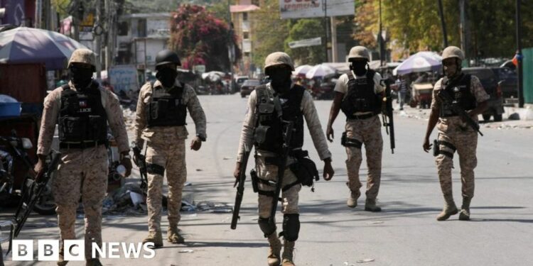 Police patrol a street in Port-au-Prince, Haiti
