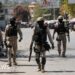 Police patrol a street in Port-au-Prince, Haiti