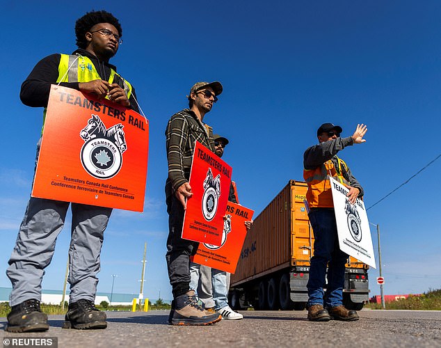 Canadian National Railway (CN) and Canadian Pacific Kansas City (CPKC) locked out more than 9,000 employees Thursday after the companies and union leaders failed to reach a contract agreement. Pictured: CPKC workers on the picket line today in Vaughan yard, Toronto