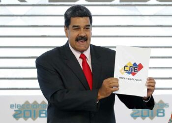 In this May 22, 2018, file photo, Venezuela's President Nicolas Maduro holds up the National El ...