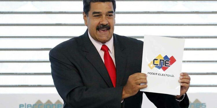 In this May 22, 2018, file photo, Venezuela's President Nicolas Maduro holds up the National El ...