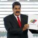 In this May 22, 2018, file photo, Venezuela's President Nicolas Maduro holds up the National El ...