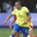 Marta on the ball for Brazil, in a yellow shirt and blue shirts, in the women