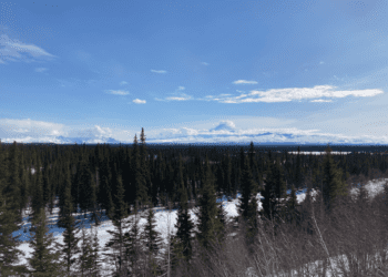 A cloud-covered Mount Wrangell is in the distance in a view south from the Tok Cut-Off on April 27, 2022. (Photo by Andrew Kitchenman/Alaska Beacon)