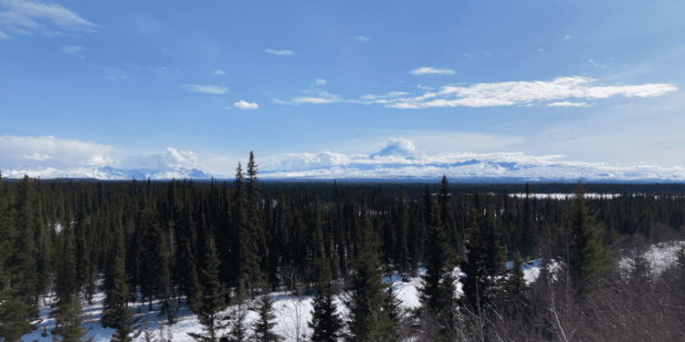 A cloud-covered Mount Wrangell is in the distance in a view south from the Tok Cut-Off on April 27, 2022. (Photo by Andrew Kitchenman/Alaska Beacon)