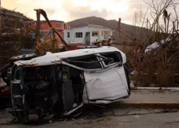 Paul Blake/BBC Debris and an overturned car on British Virgin islands