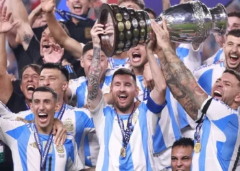 Angel Di Maria, Lionel Messi and Nicolas Otamendi of Argentina celebrate with the trophy after the team's victory in the CONMEBOL Copa America 2024 Final match between Argentina and Colombia at Hard Rock Stadium on July 15, 2024 in Miami Gardens, Florida.