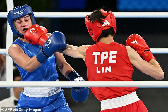 Taiwan's Lin Yu-ting and Poland's Julia Szeremeta (Blue) compete in the women's 57kg final boxing match during the Paris 2024 Olympic Games at the Roland-Garros Stadium, in Paris on August 10, 2024. (Photo by MOHD RASFAN / AFP) (Photo by MOHD RASFAN/AFP via Getty Images)