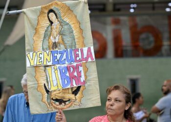 A woman holds an image of Our Lady of Guadalupe with the words Free Venezuela during a vigil called by the opposition demanding freedom for political prisoners arrested during protest following the contested re-election of Venezuelan President Nicolas Maduro in Caracas, August 8, 2024.