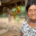 BBC  Tsimane woman with dark hair pinned up, wearing a white top with black flowers and a necklace