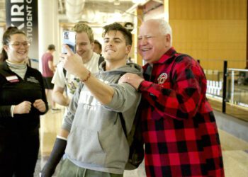 Minnesota Gov. Tim Walz has his photo taken with young fans.